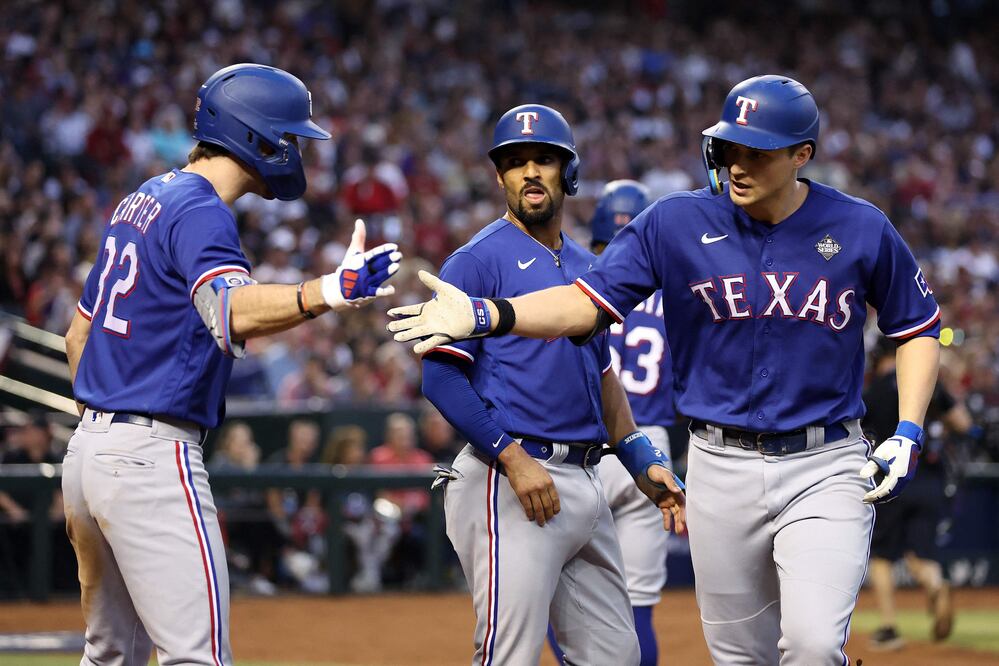 PHOENIX, ARIZONA - OCTOBER 30: Evan Carter #32 and Corey Seager #5 of the Texas Rangers celebrate after Seager hit a home run in the third inning against the Arizona Diamondbacks during Game Three of the World Series at Chase Field on October 30, 2023 in Phoenix, Arizona. Christian Petersen/Getty Images/AFP (Photo by Christian Petersen / GETTY IMAGES NORTH AMERICA / Getty Images via AFP)
