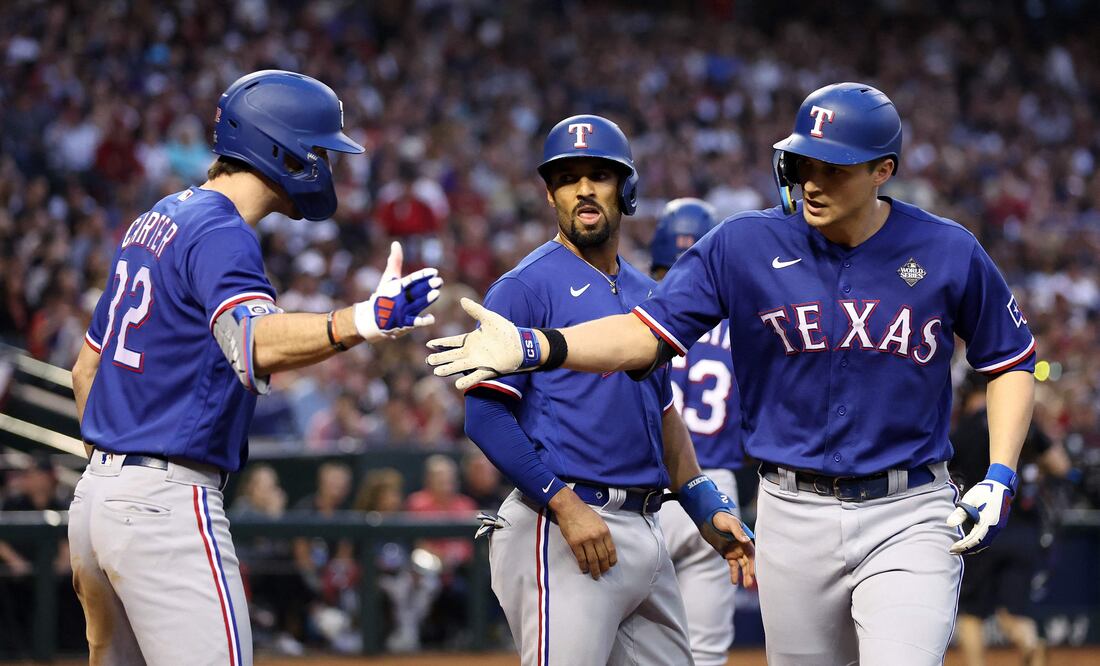 PHOENIX, ARIZONA - OCTOBER 30: Evan Carter #32 and Corey Seager #5 of the Texas Rangers celebrate after Seager hit a home run in the third inning against the Arizona Diamondbacks during Game Three of the World Series at Chase Field on October 30, 2023 in Phoenix, Arizona.   Christian Petersen/Getty Images/AFP (Photo by Christian Petersen / GETTY IMAGES NORTH AMERICA / Getty Images via AFP)