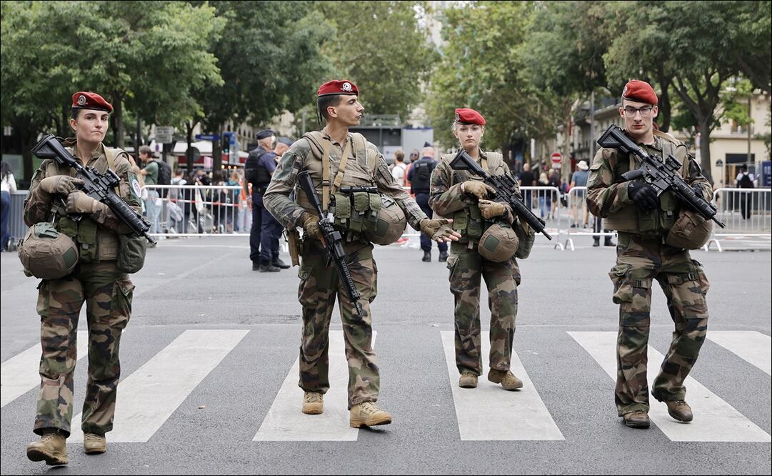 Elementos de la policía y militares de París resguardan los alrededores de la zona donde se realizará la inauguración de los Juegos Olímpicos. FOTO: EFE