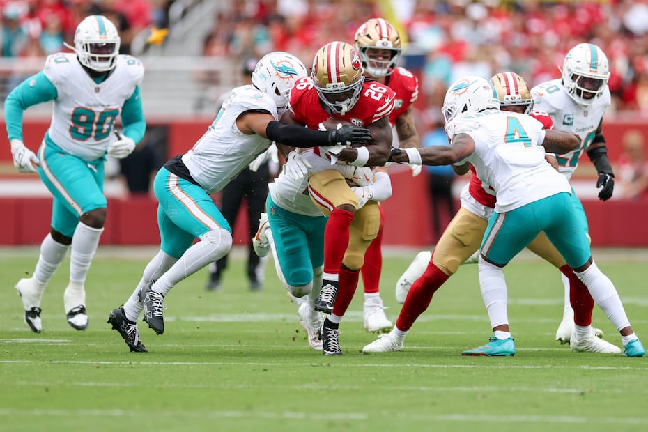 SANTA CLARA, CALIFORNIA - SEPTEMBER 20: Kaelon Black #26 of the San Francisco 49ers runs the ball against Dante Trader Jr. #11 and Jason Marshall Jr. #4 of the Miami Dolphins in the third quarter of a game at Levi's Stadium on September 20, 2026 in Santa Clara, California. Ezra Shaw/Getty Images/AFP