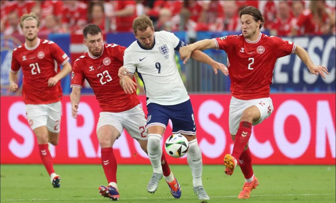 Harry Kane intenta salir avante en medio de dos defensores de Dinamarca. FOTO: @UEFA
