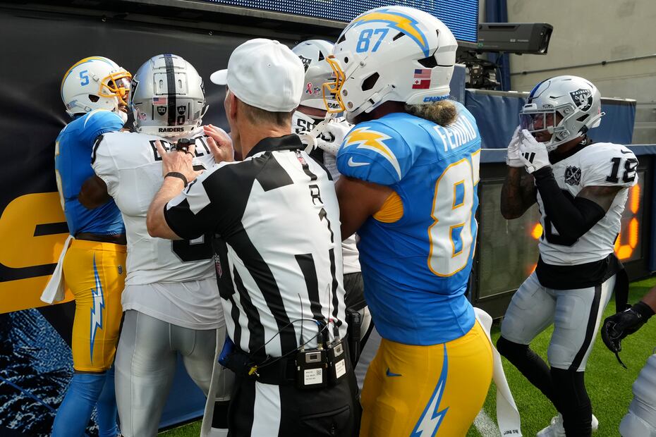 Los oficiales del partido intentan separar a los jugadores de Raiders y Chargers. FOTO: AP
