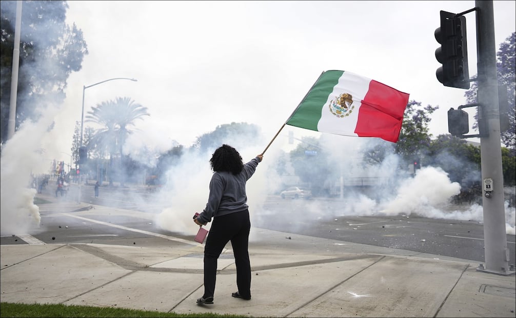Una mujer ondea la bandera mexicana en medio de las protestas por las redadas contra inmigrantes en Los Ángeles / Foto: AP